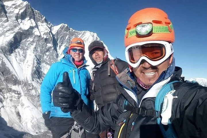 Climbers in helmets and goggles below the Lhotse wall on an Everest climbing tour to Island Peak, Khumbu, Nepal