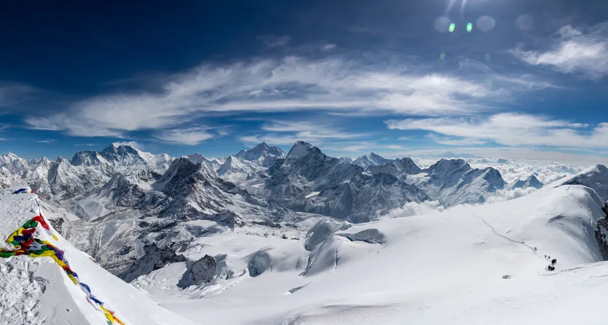 Prayer flags on the summit of Mera Peak on Everest climbing tours to a trekking peak, Nepal